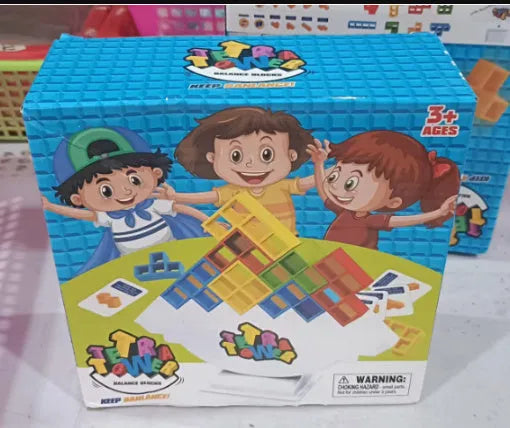 Plastic balance stacking board game with 16 coloured blocks, chassis, and base on a table