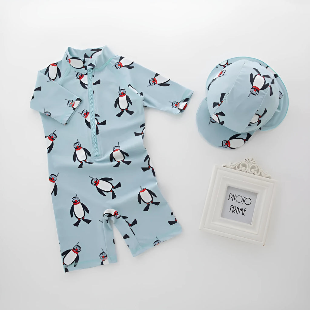 Boys' penguin print long sleeve swim shirt and matching swim cap set.