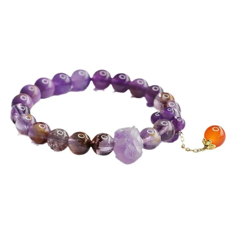 Close-up of a nine purple Fire Duobao and amethyst crystal bracelet with red agate stones, Mori style.