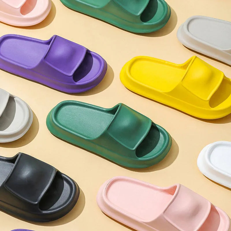 Thickened EVA non-slip flip-flop slippers in multiple colours on a bathroom floor.