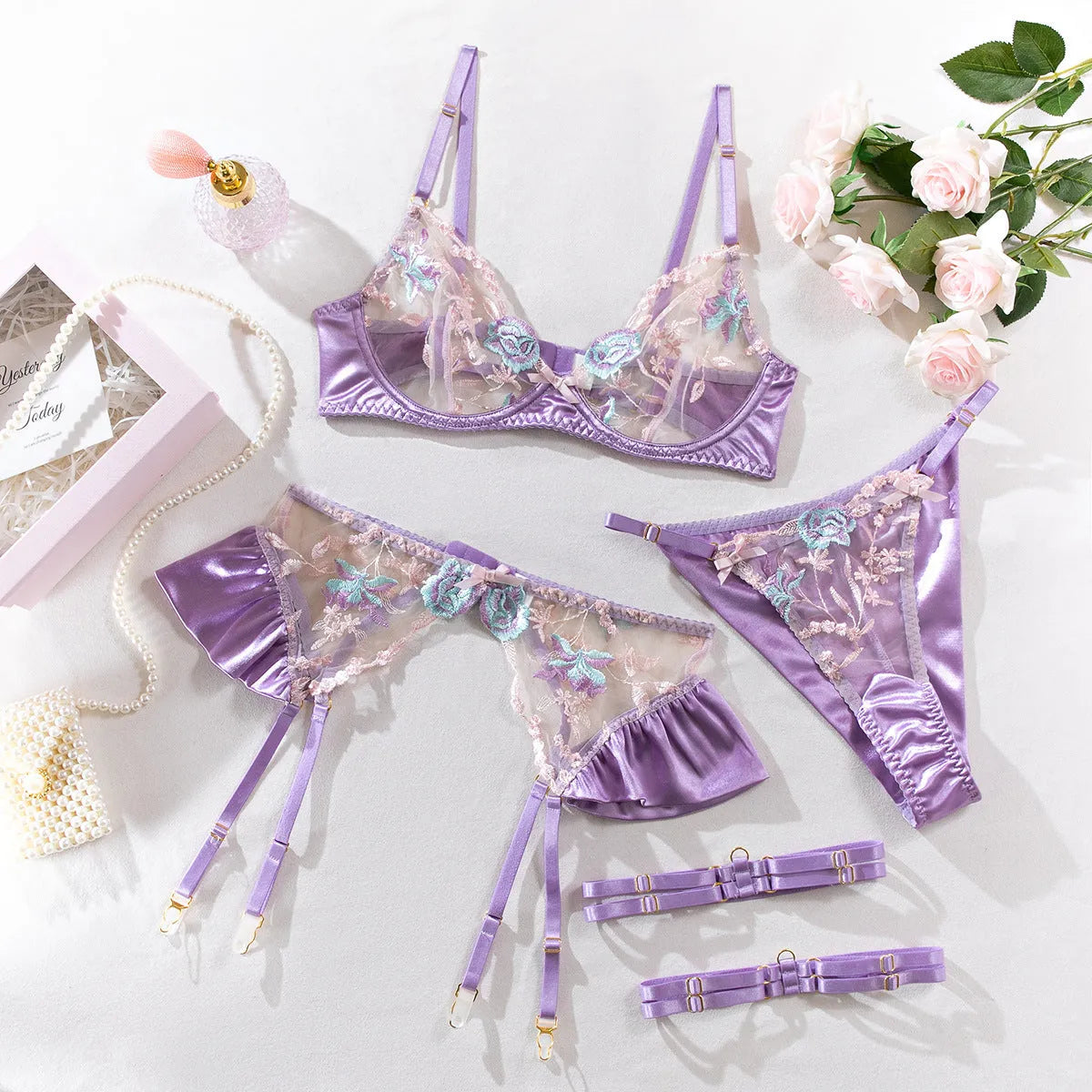 Light purple satin four-piece lingerie set with embroidery detailing