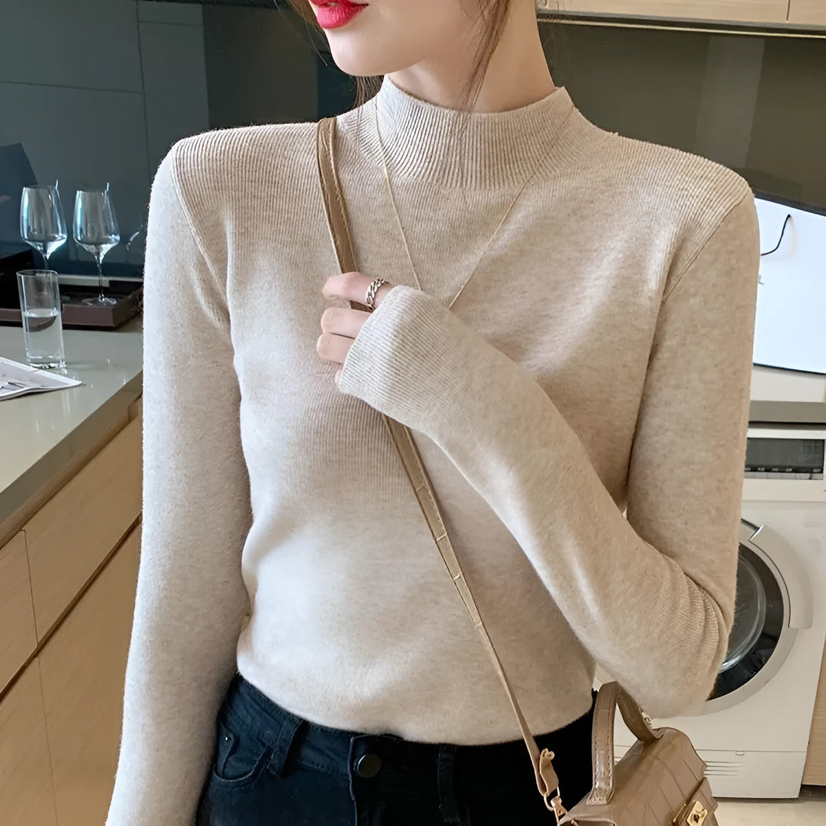 Women's slim fit long sleeve viscose pullover top in apricot colour on a hanger.