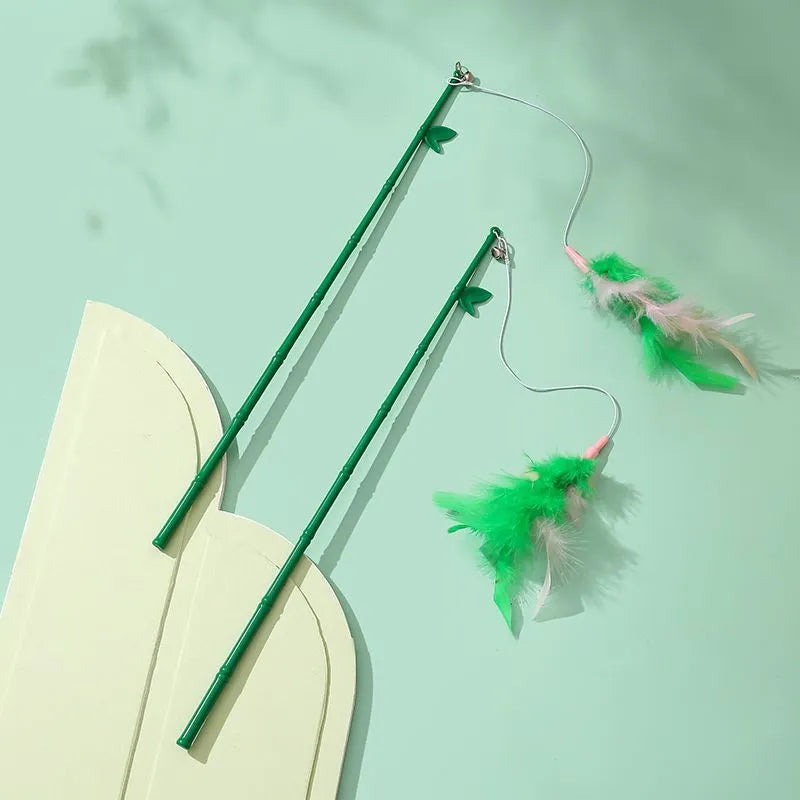 Green cat feather wand toy with bells and feather attachments for interactive feline play