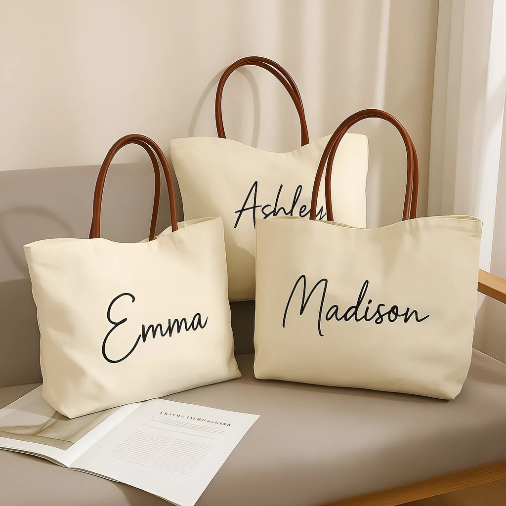 Beige white and white canvas tote bag with long handle straps.