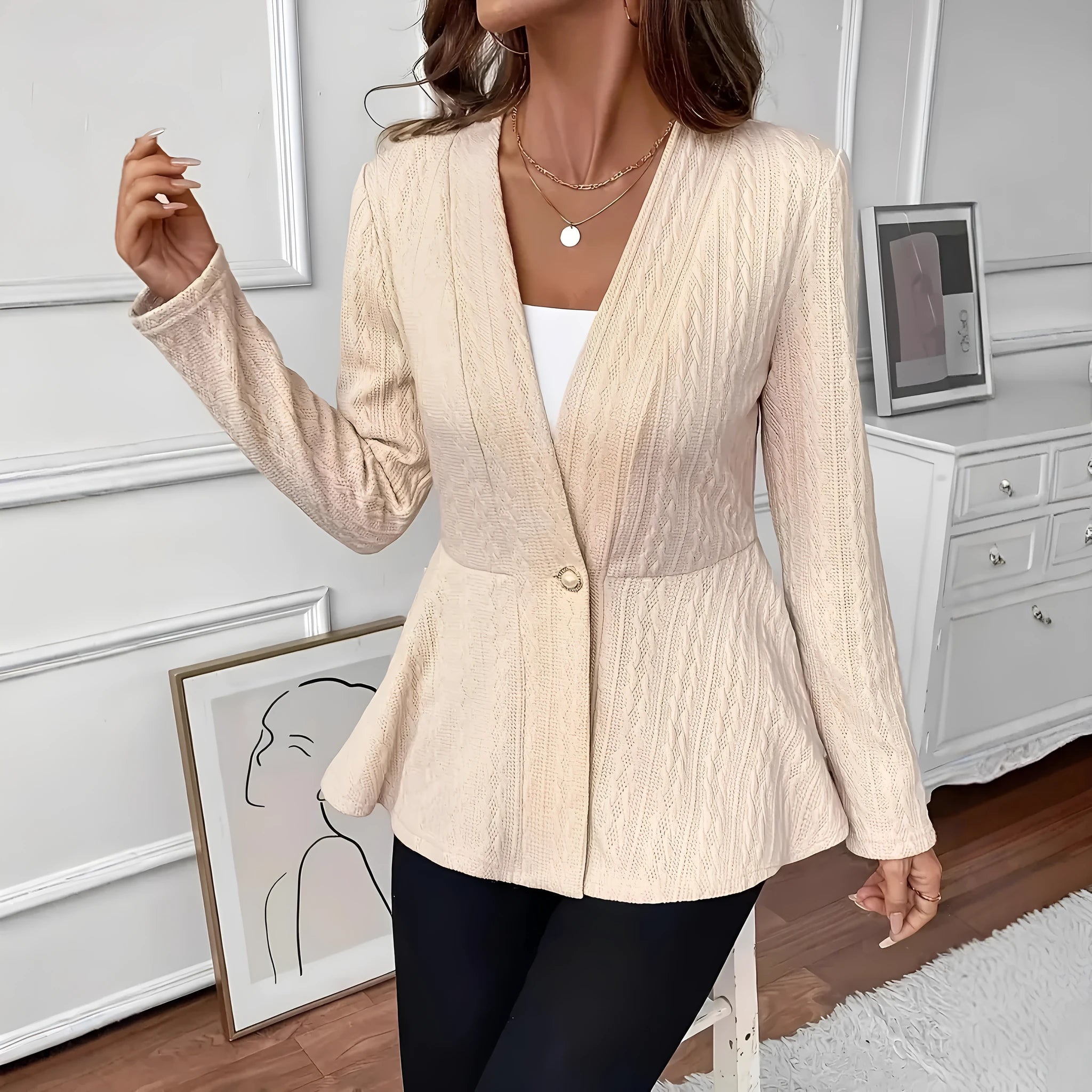 Women's apricot jacquard knit cardigan with one button front, shown on a model.