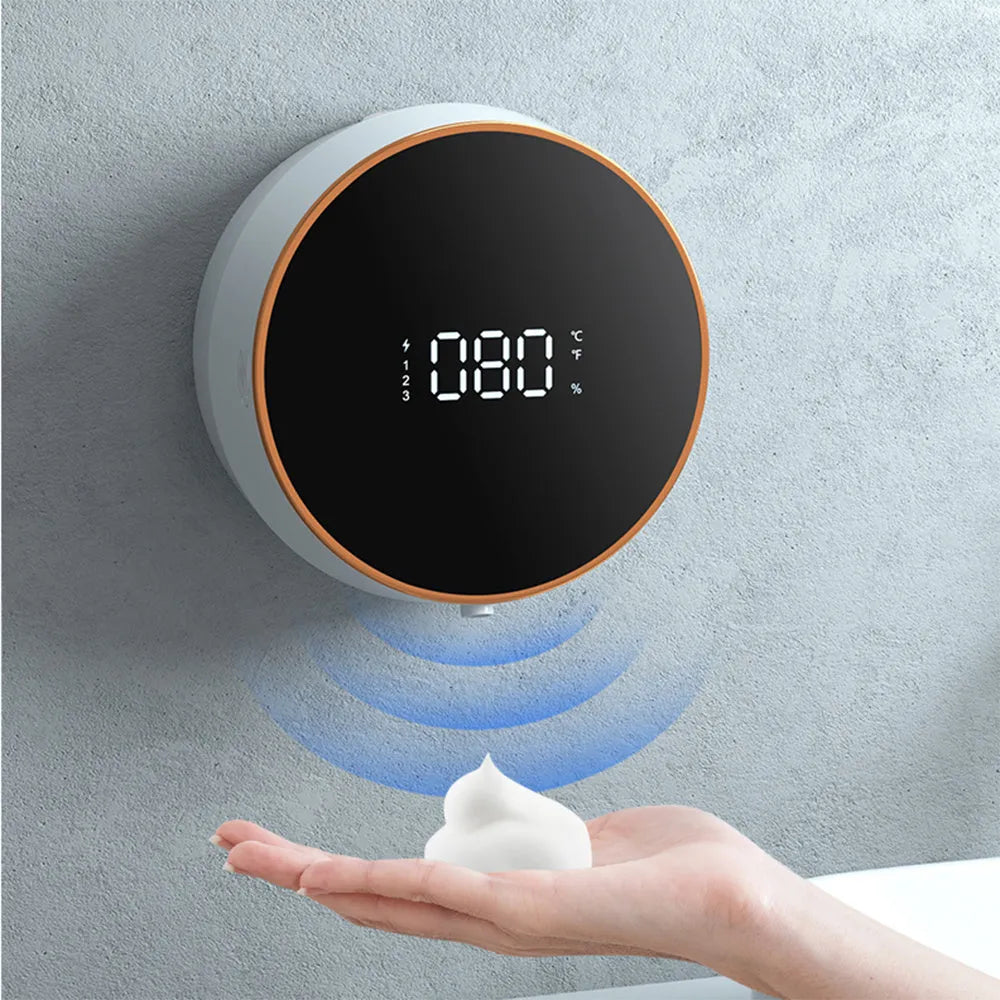 Automatic sensor foam soap dispenser in black mounted on a bathroom wall.