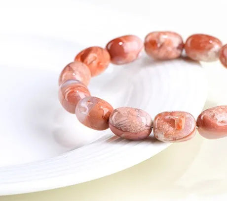 Natural cherry agate barrel bead bracelet with Ruyi elements measuring 10x14mm