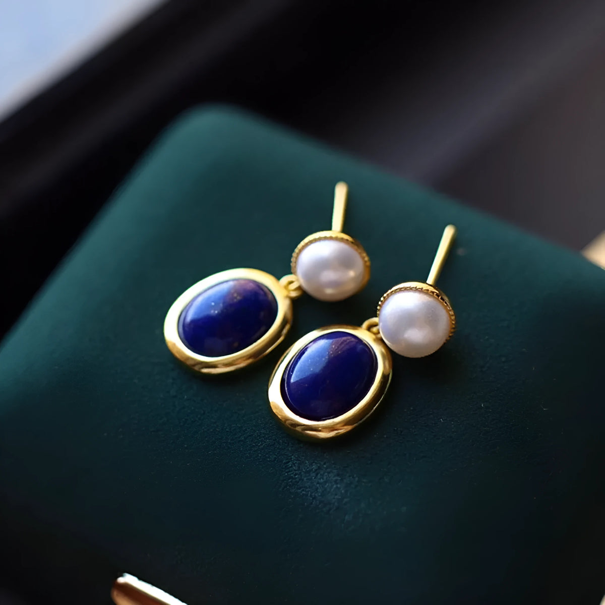 Simple drop earrings with a blue Lapis Lazuli pearl set in sterling silver, featuring auspicious pattern details.