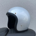 Glass fibre retro motorcycle half helmet shown in cement grey colour on size M
