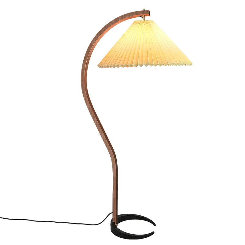 Retro-style vertical table lamp with log white lampshade placed on a sofa arm.