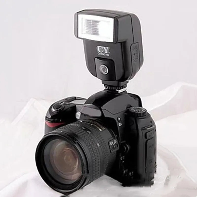SLR camera flash accessory with tilted head shown on a hot shoe, displaying compact size.
