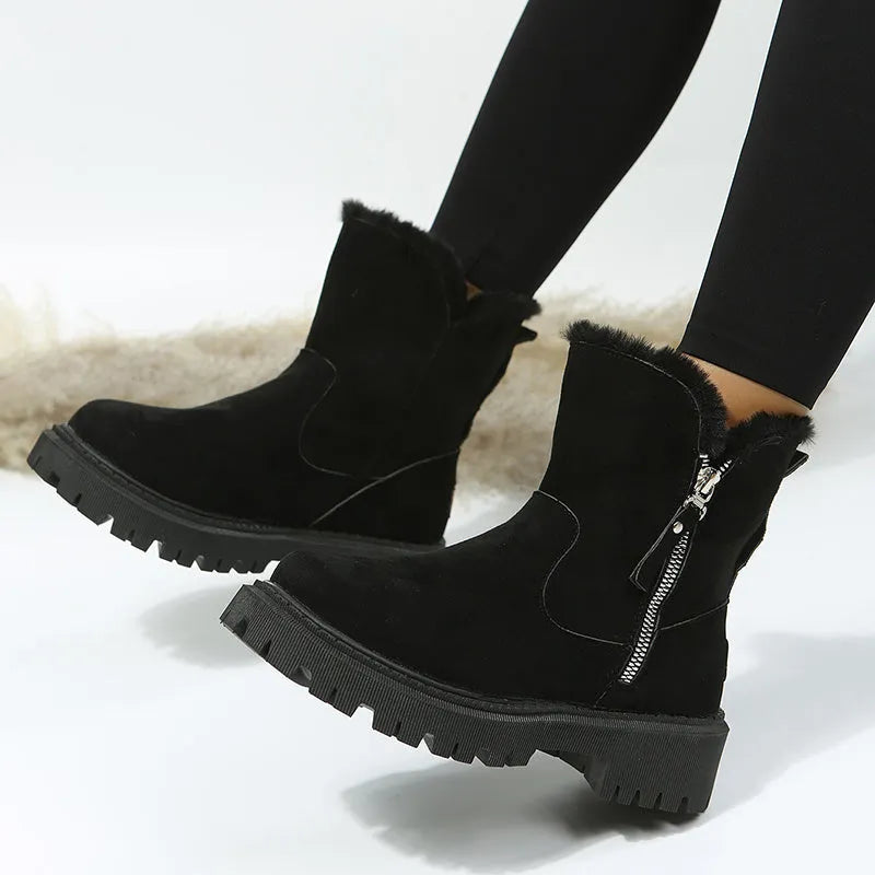 Women's black high-top snow boots with faux suede uppers, side zipper, and fluffy fur lining.