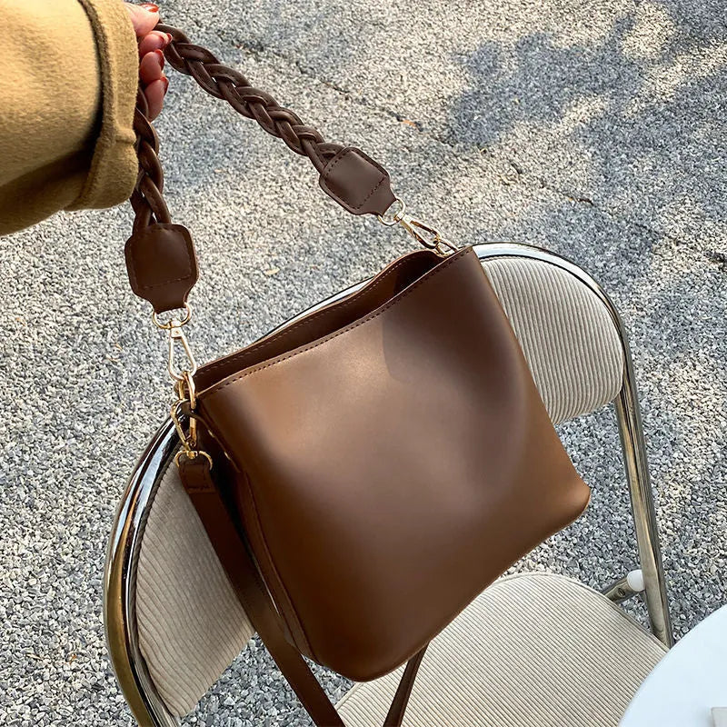 Retro woven PU leather one-shoulder crossbody bucket bag shown in khaki, black, and brown colour options.