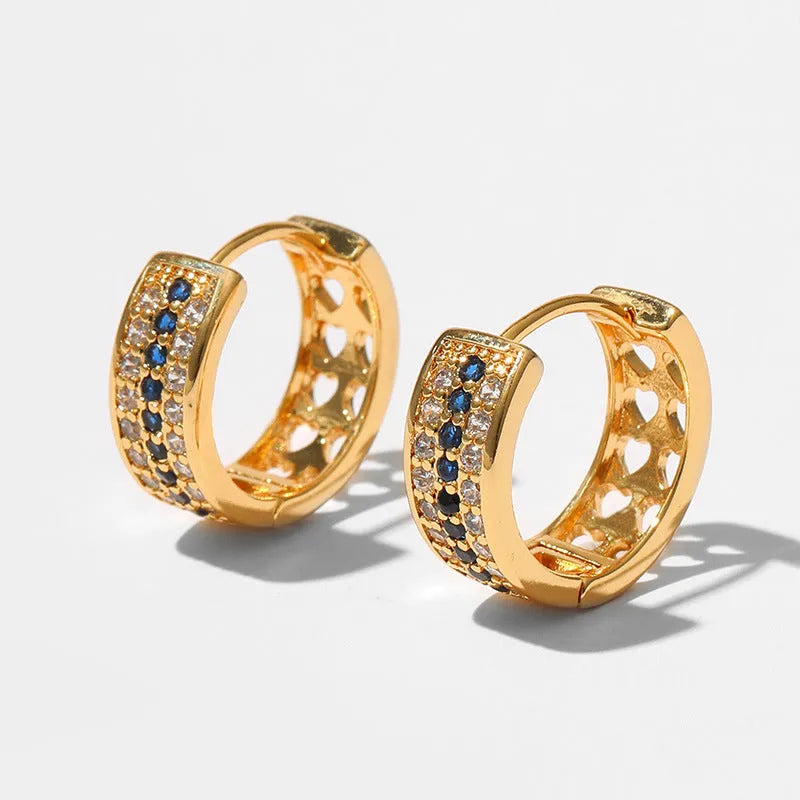 Round geometric women's earrings with copper construction and 18K gold electroplated finish.