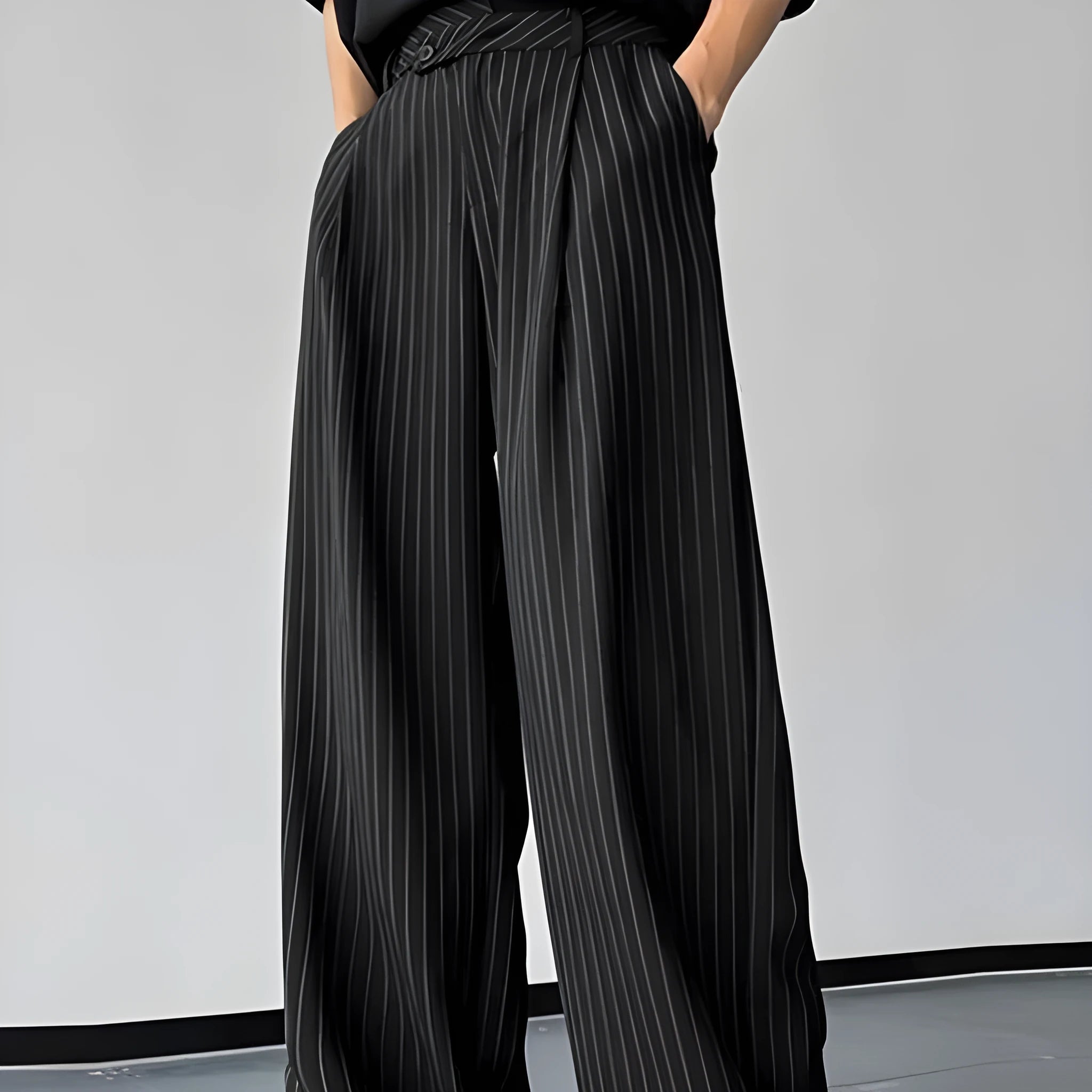 Men's black vertical striped pleated casual trousers with high elasticity fabric, laid flat.