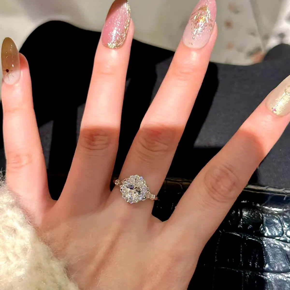 Silver geometric women's ring with large diamond bouquet detail and adjustable opening.