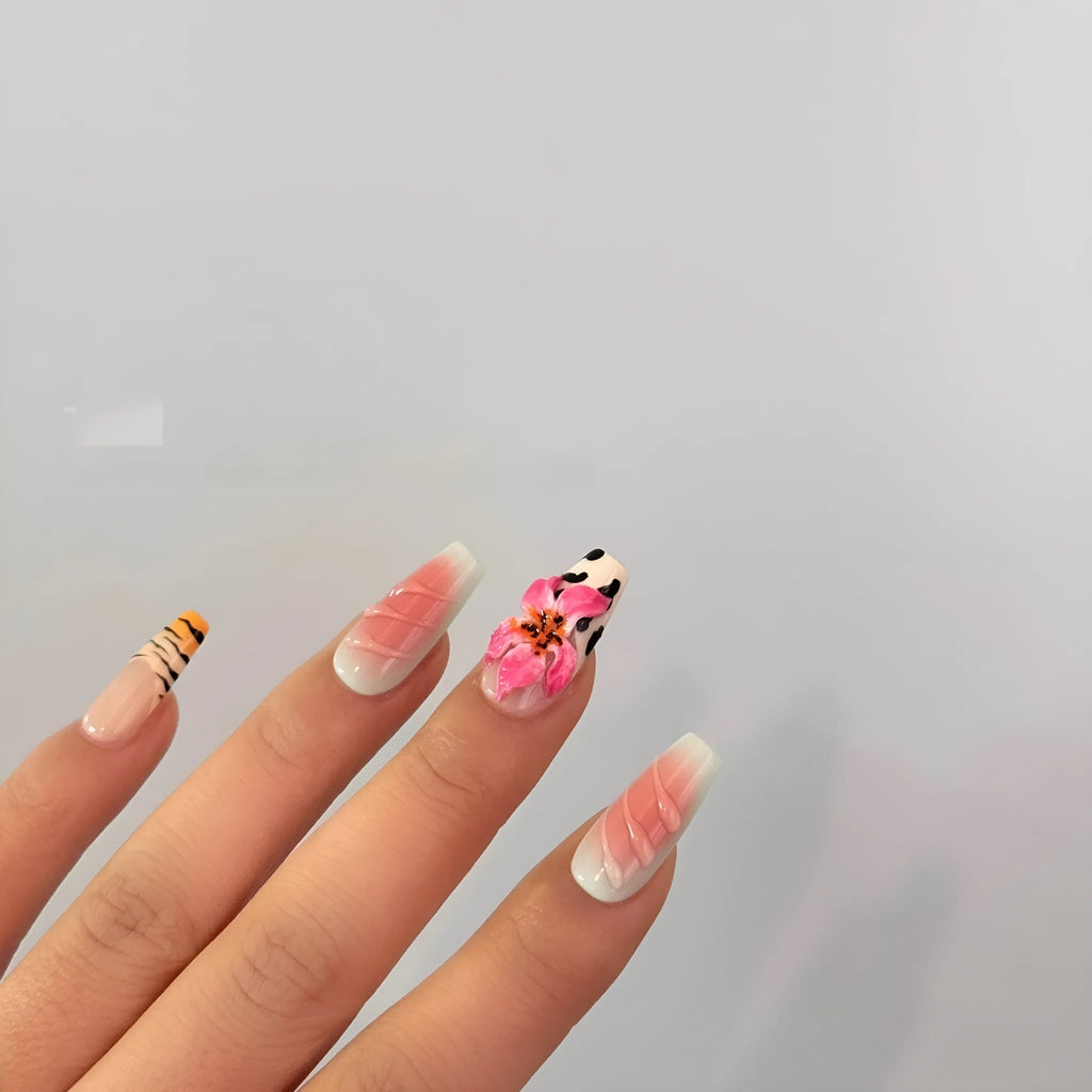 Hand-carved zebra pattern and lily design nail art pieces in four sizes on a clear background.