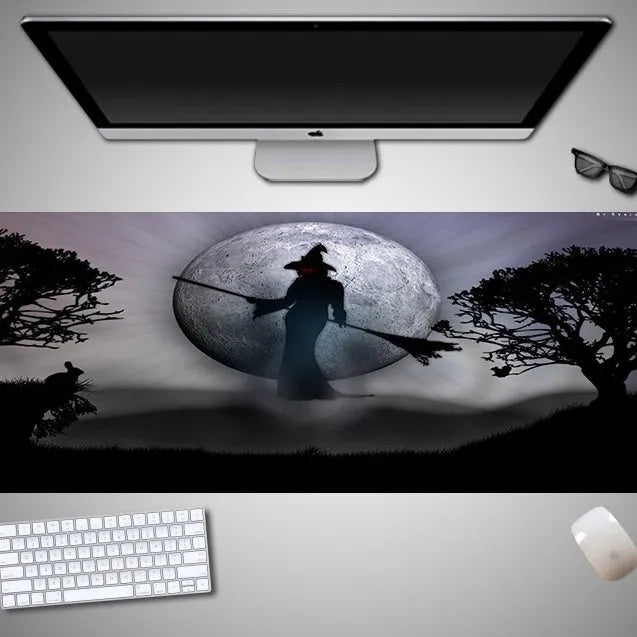 Oversized Halloween pattern mouse pad on a desk showing non-slip rubber base and cloth top.