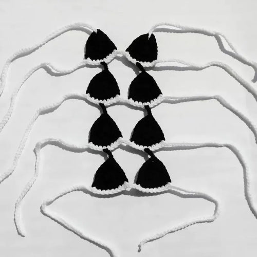 Colourful bikini costume for a cat or small dog on a white background.