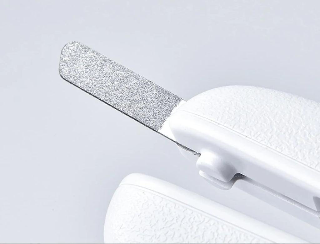 White pet nail clipper with LED light on handle and transparent anti-splash guard surrounding the blades.