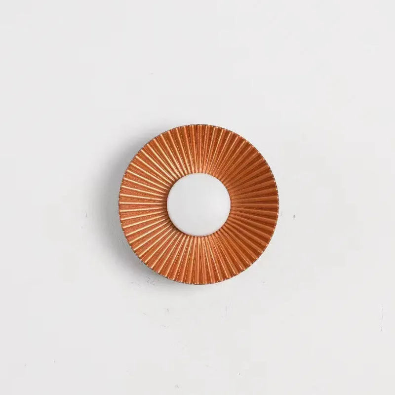 Round aluminium wall lamp with white and gold colour options mounted on wall