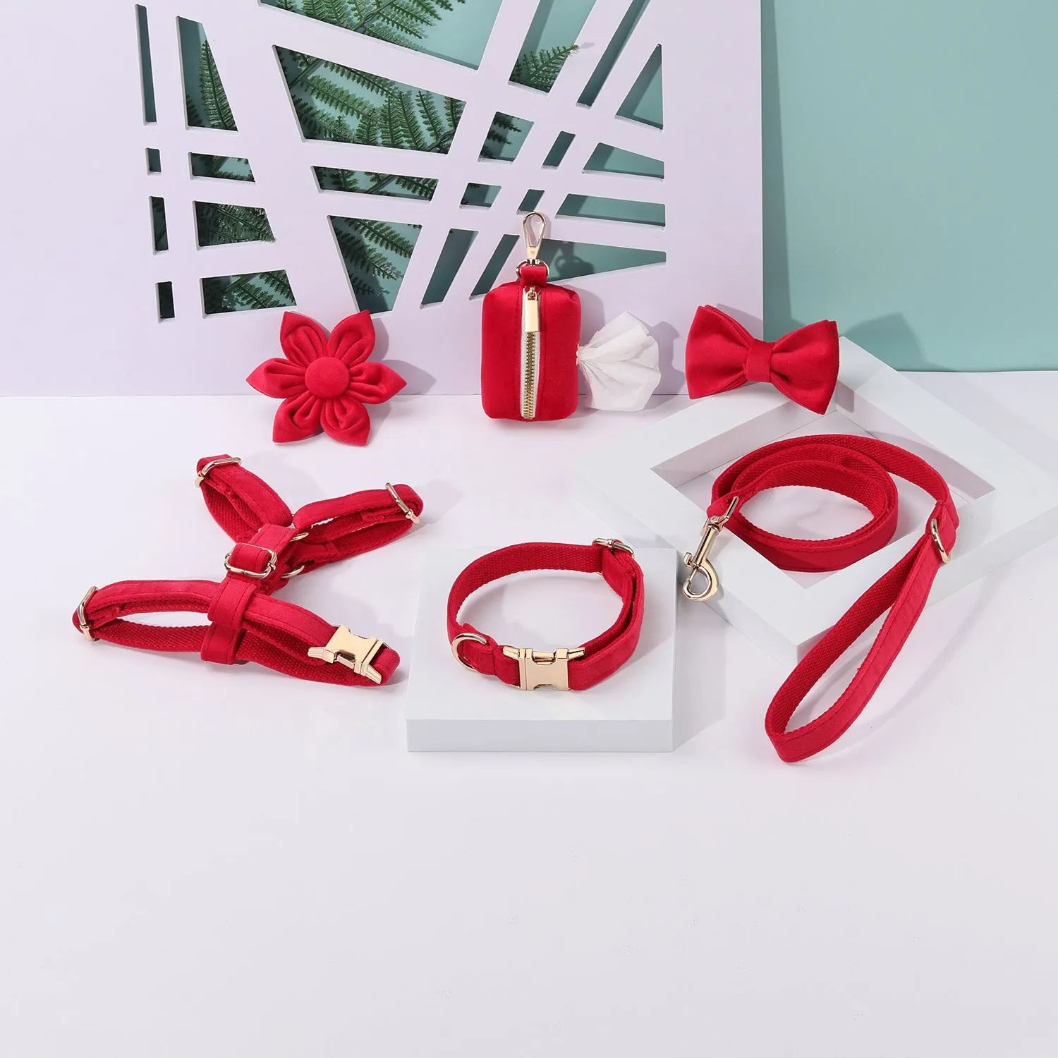 Complete velvet dog collar and traction rope set with bow tie, flower, and toilet bag on a table