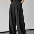 Men's black vertical striped pleated casual trousers with high elasticity fabric, laid flat.