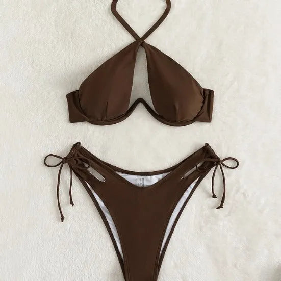 Women's solid colour halter bikini swimsuit with backless briefs in black, blue, or brown.