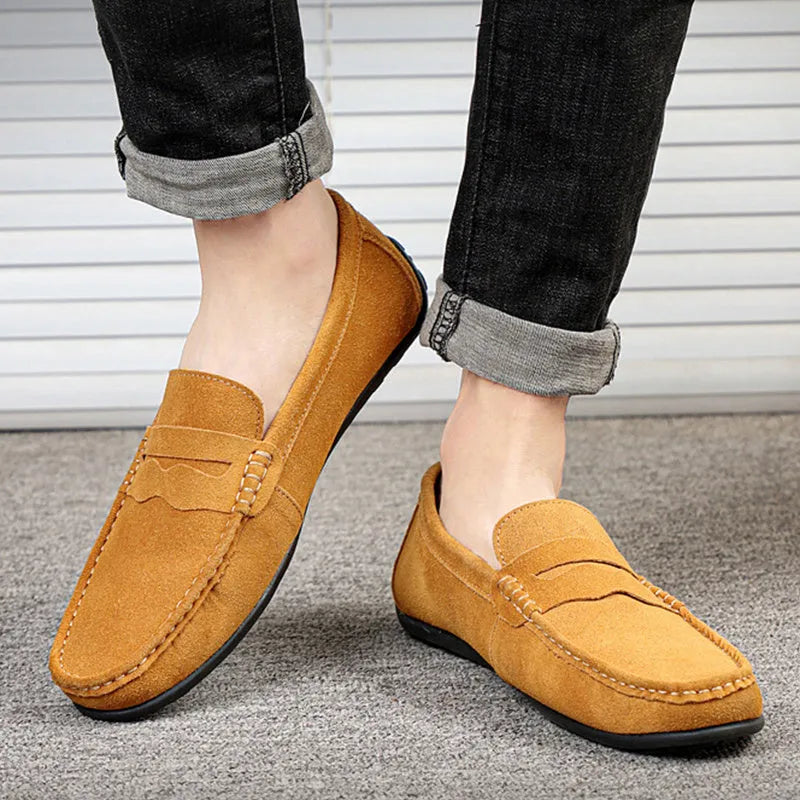 Men's solid colour suede slip-on loafers with a round toe and flat rubber sole.