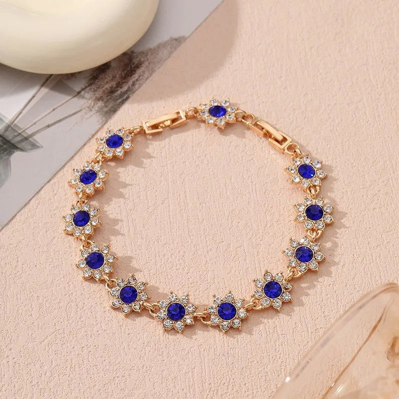 Flower-shaped bracelet with gemstone accents in gold or silver electroplated finish showing twelve colour combination options