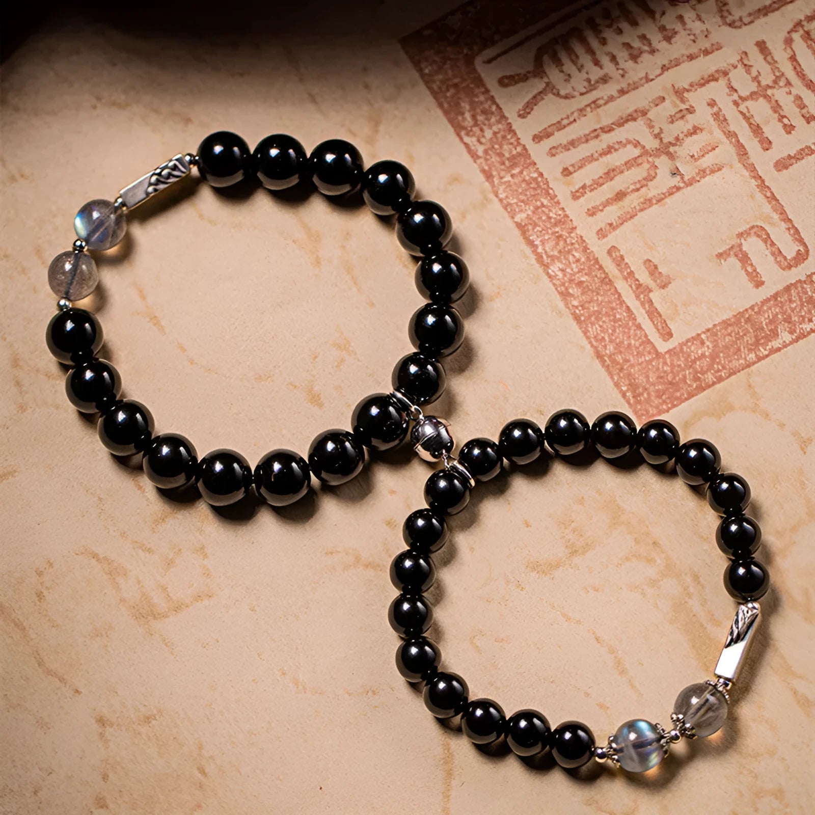 Obsidian Buddha beads couple bracelet set showing 8mm women's and 10mm men's sizing in national style