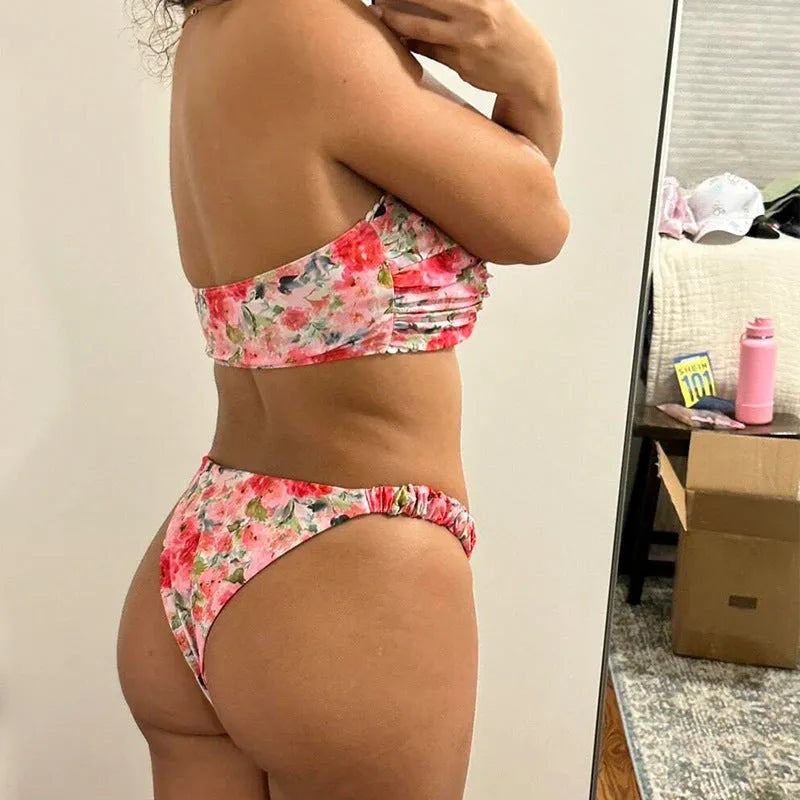 Women's floral print polyester bikini set in blue on a mannequin, showing tube top and briefs.