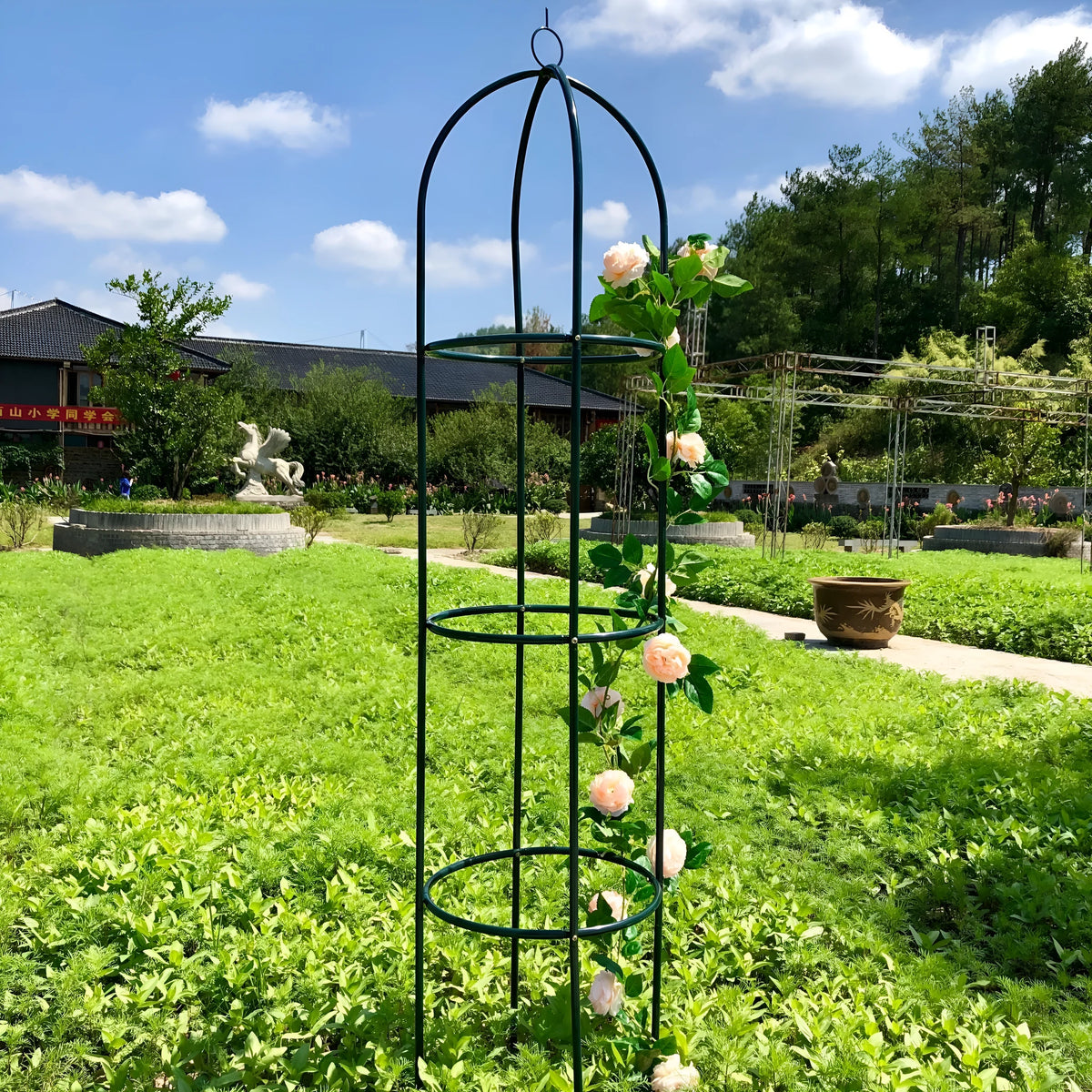 Dark green European-style wrought iron plant climbing frame lattice standing on floor.