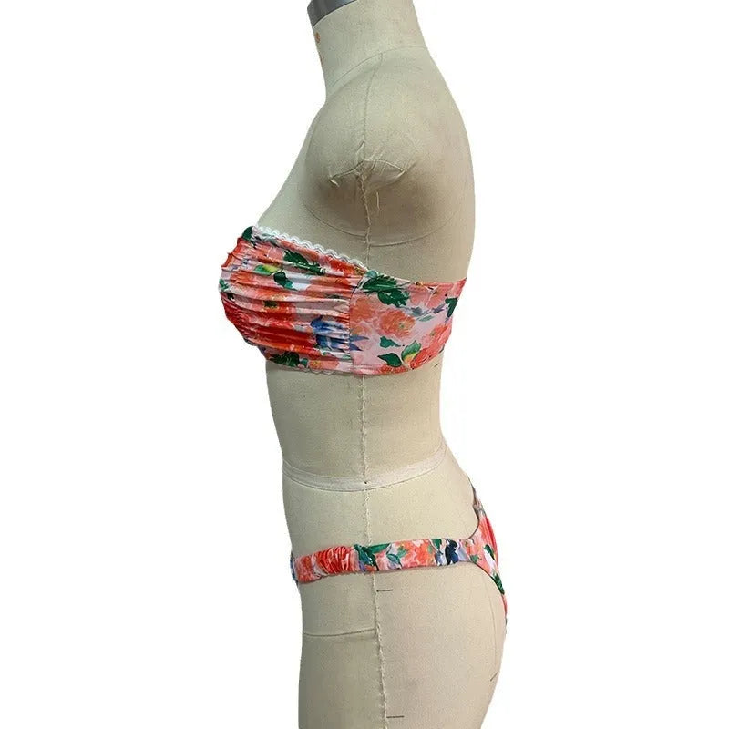 Women's floral print polyester bikini set in blue on a mannequin, showing tube top and briefs.