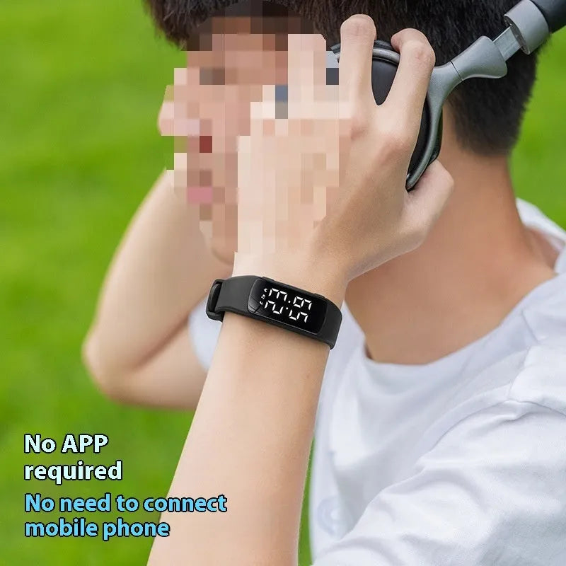 Smart vibration alarm clock watch with coloured silicone strap and LED display on a wrist.