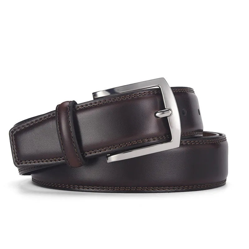 Men's black leather belt with a silver alloy pin buckle on a wooden background.