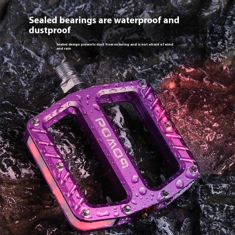 Bicycle pedal with integrated LED lights in aluminium alloy construction showing colour options