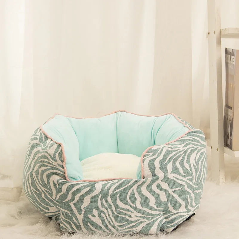 Octagonal grey pet bed with soft padded rim and removable inner mat for a small dog