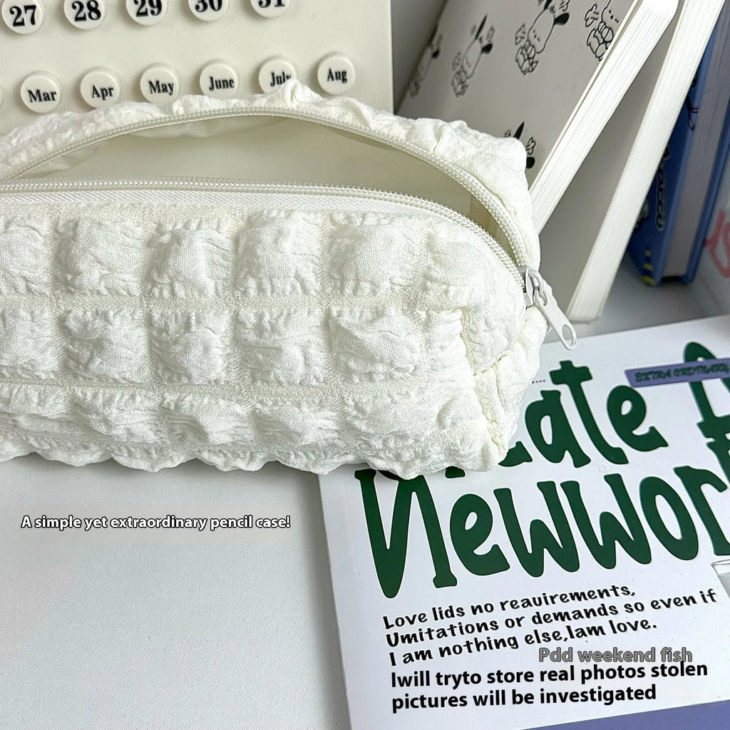 Beige or black polyester fabric pencil case with cream puff style texture and zip closure