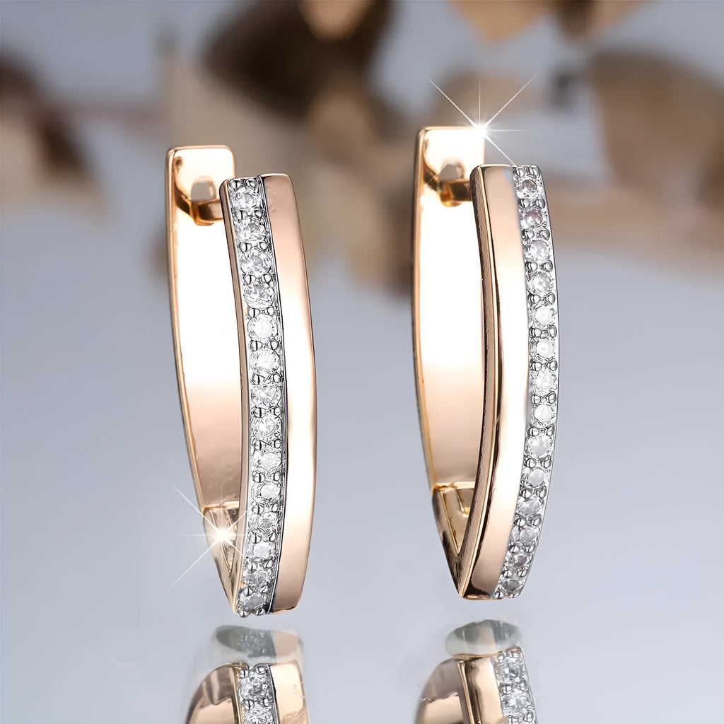 Geometric V-shaped champagne gold women's ear clips with white diamond accents.