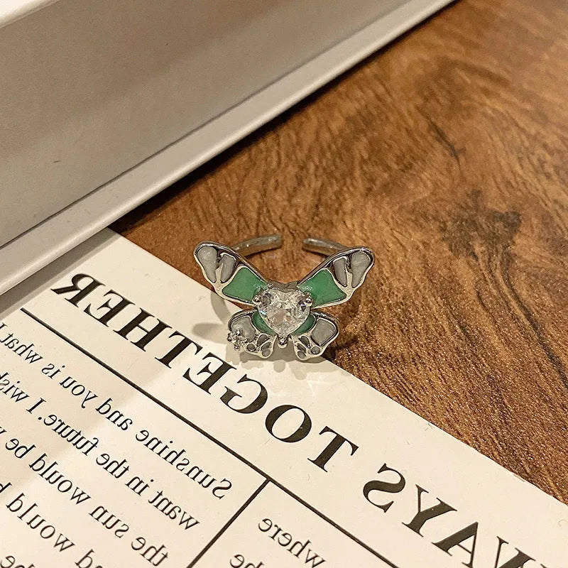 Copper butterfly women's ring with drip oil finish in an open-loop design.