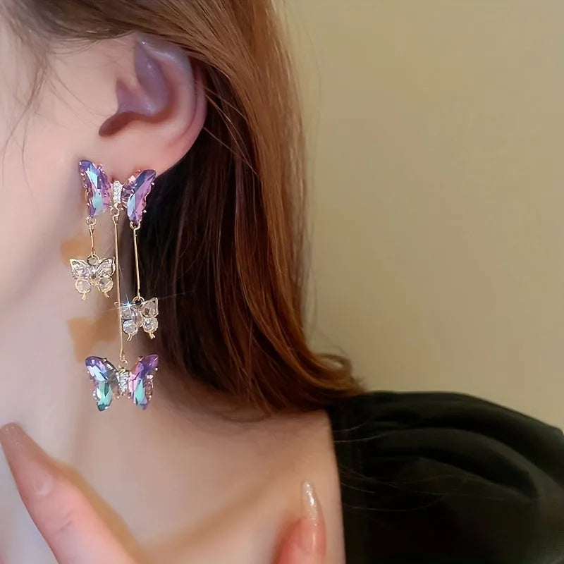 Silver needle blue purple butterfly tassel drop earrings with crystal flower details on alloy.