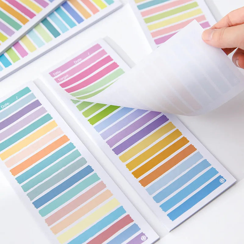 Cartoon student notepad in plastic storage box showing colourful striped and bear designs