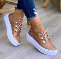 Women's white lace-up flats sneakers with round toe and silver rivet detail on the artificial PU upper.