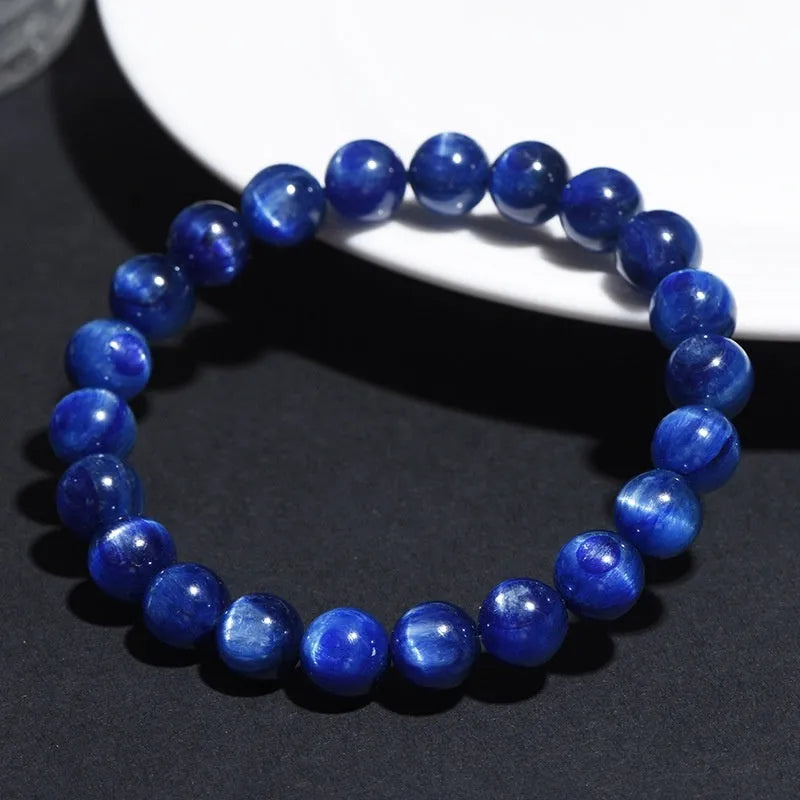 Natural blue crystal geometry ball bracelet with Ruyi charm on a white background.