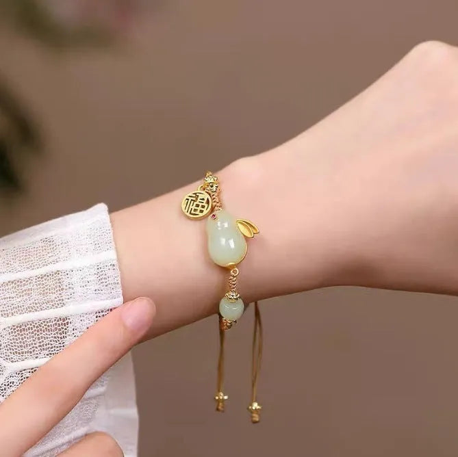 Yellow string bracelet with a geometric Hetian jade rabbit charm for women.