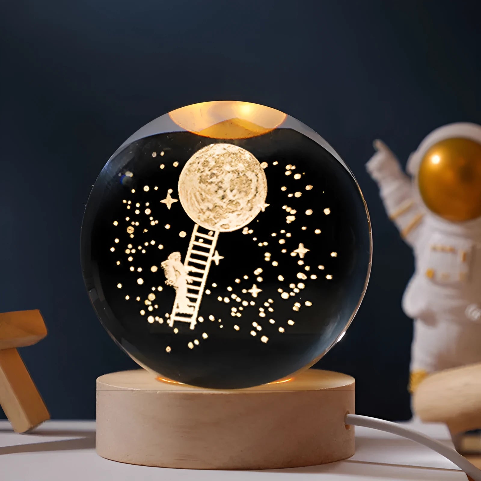 Luminous crystal ball with starry sky effect on wooden base, USB cable connected