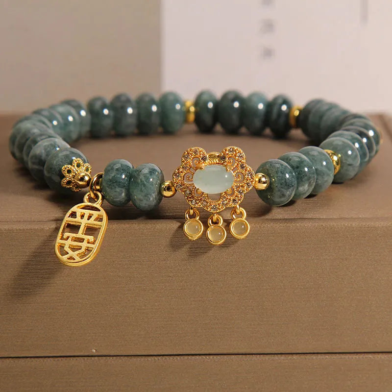 Natural emerald jade abacus bead bracelet for women with a metal safety lock closure.