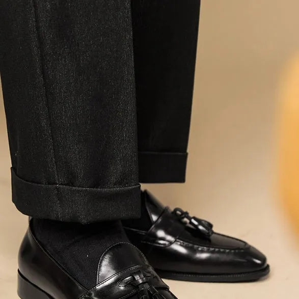 British-style leather tassel loafers in polished black leather with rubber sole