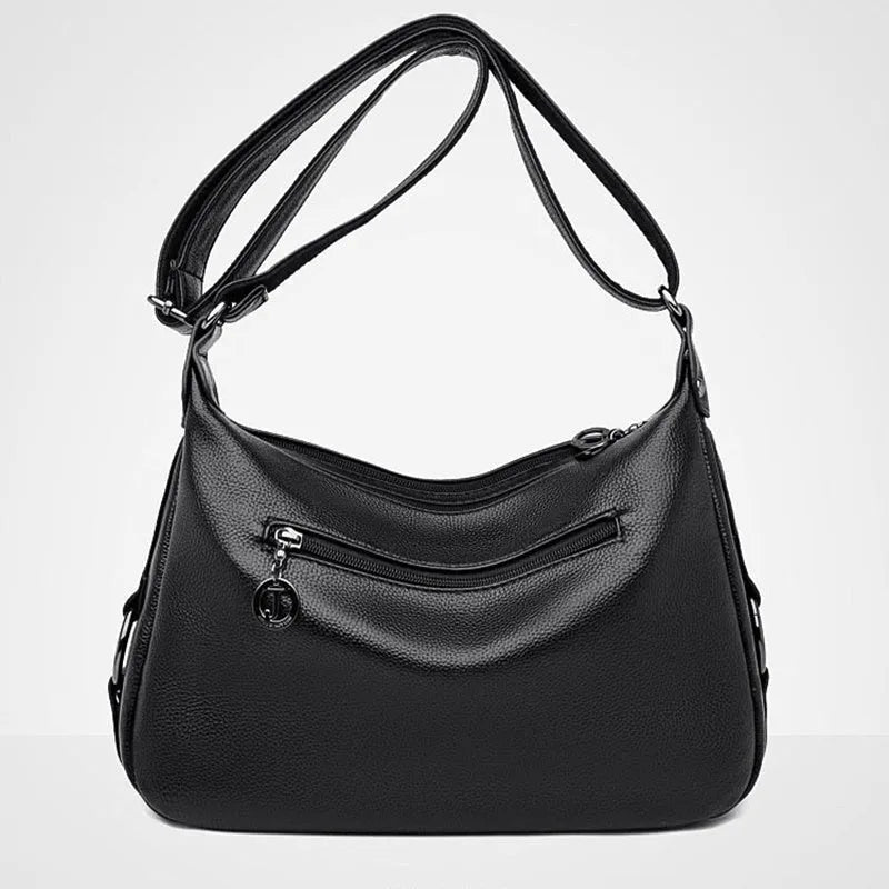 Large black or blue PU crossbody bag with organised internal compartments and soft handle
